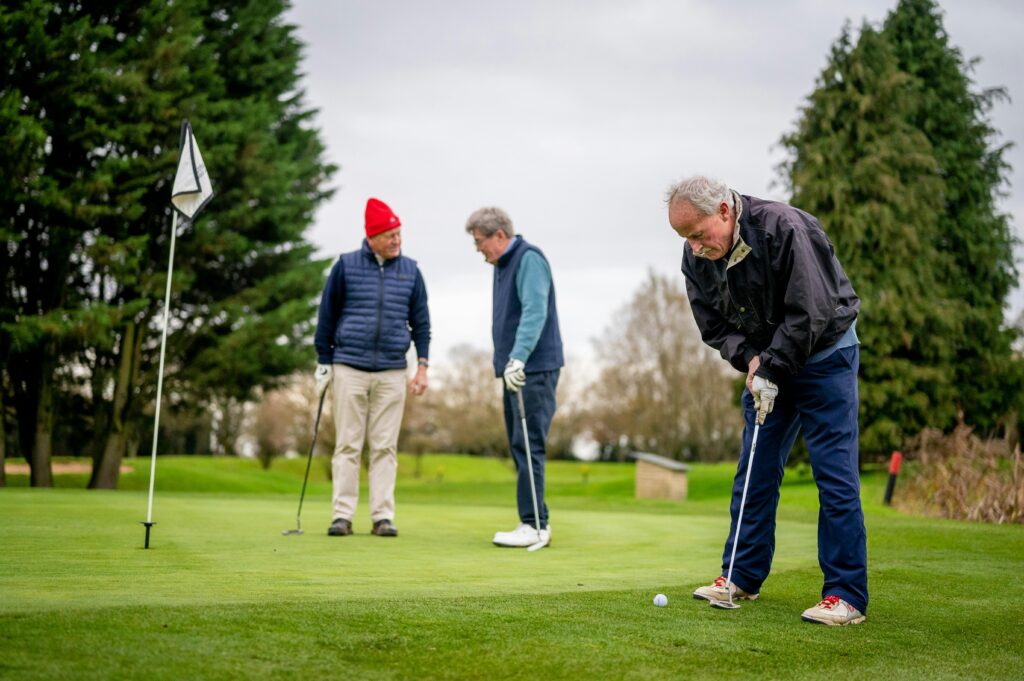 pexels-photo-7858233-7858233 Three senior men enjoying a day of golf on a lush green course.